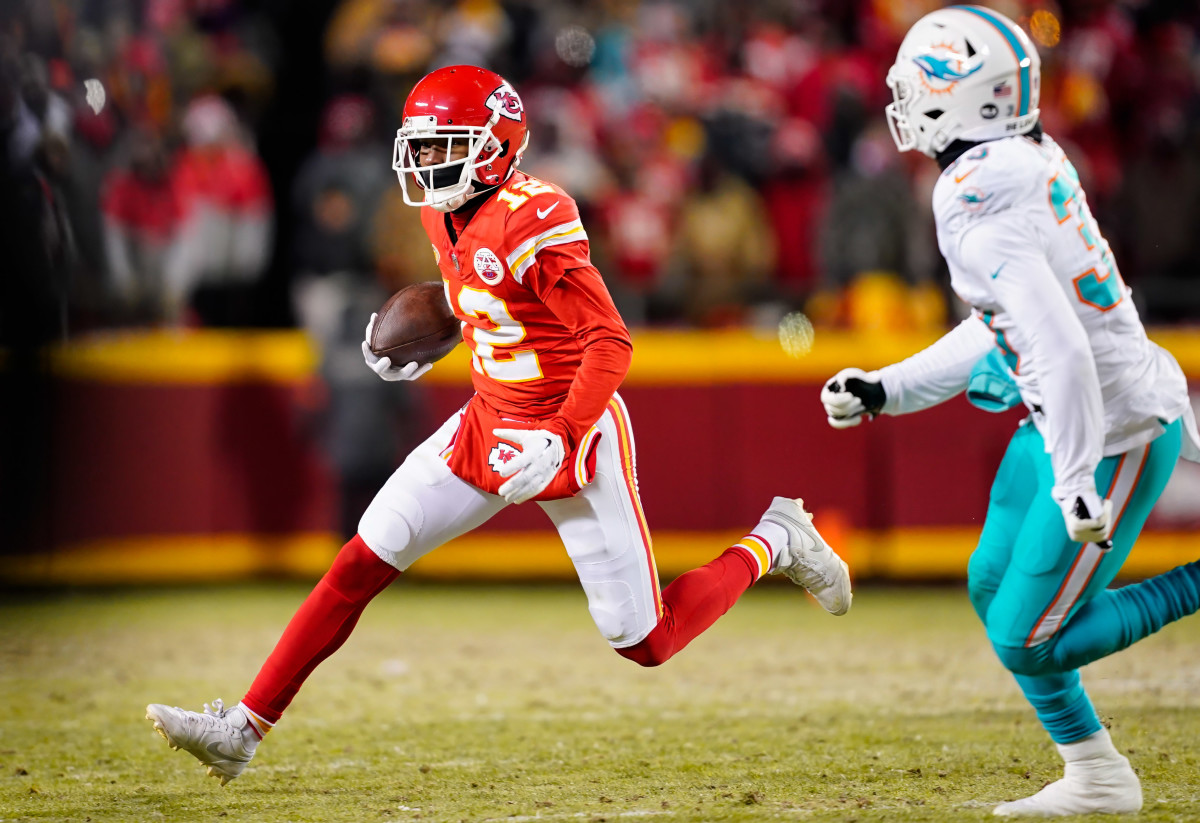 Jan 13, 2024; Kansas City, Missouri, USA; Kansas City Chiefs wide receiver Mecole Hardman Jr. (12) runs with the ball against Miami Dolphins cornerback Eli Apple (33) during the first half of a 2024 AFC wild card game at GEHA Field at Arrowhead Stadium. © Jay Biggerstaff-USA TODAY Sports